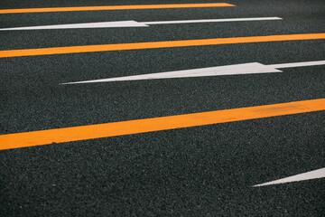 Directional arrows on an asphalted road.