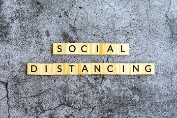 Social distancing text on wooden block textures background