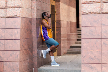 Young African American Male Listening To Music With Headphone 