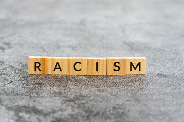 Racism text on wooden block textures background