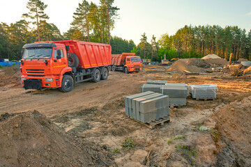 Road works, pavement renovation, asphalting at construction site. Screeding sand for installing borders, curbs and concrete blocks on the road. Laying paving slabs and bricks in the pedestrian zone.
