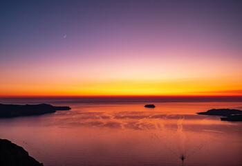 Fototapeta na wymiar Santorini's magic and romantic Atmosphere. .Sunset with moon in the horizon
