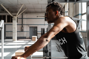 Determined athlete resting in gym