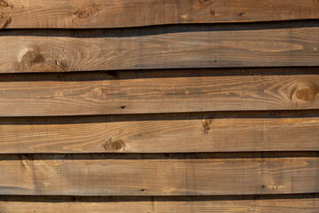 Naklejka premium Street volumetric brown wooden board with shadows. Close-up. Background.