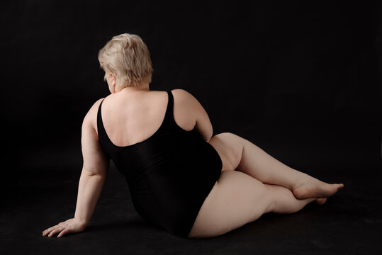 Blonde woman with overweight and short haircut posing,