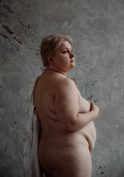 Portrait of beautiful naked huge woman hiding breast.