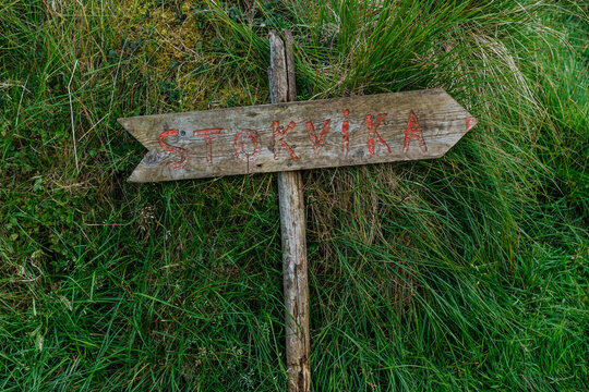 Wooden sign showing city navigation