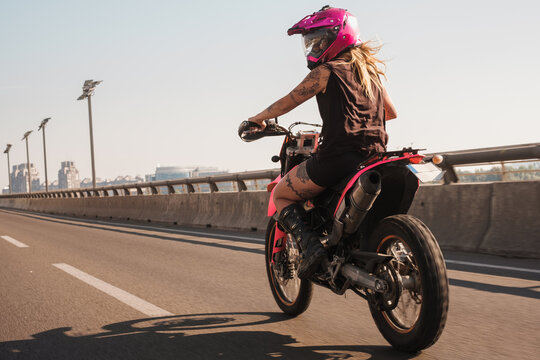 Woman Motorcyclist Riding Pink Motorbike