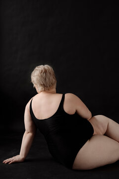 Blonde woman with overweight and short haircut posing,