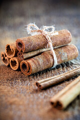cinnamon bark, used in teas, sweets, as a flavoring or culinary ingredient. Cinnamon on rustic wooden background.