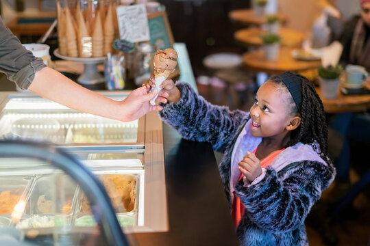 Happy girl buying ice cream
