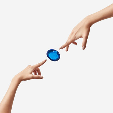 Two hands with flying condom.