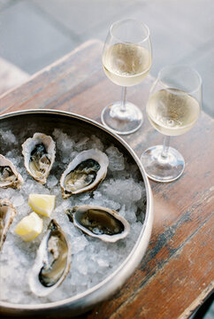 two glasses with white wine and oysters