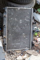 The damage of car cooling radiator. The old radiator of the damaged car.