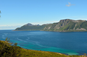 Fototapeta na wymiar summer mountain peaks and blue fjord