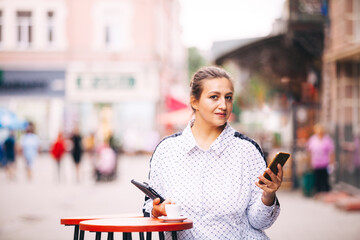 Young business lady in the street cafe