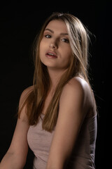 Naklejka premium Beautiful girl posing on black background. Isolated, Face Expression