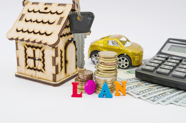 Model of a wooden house, keys, auto, money, calculator and the word 