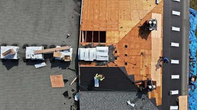 East Brunswick NJ US. 20 JUNE 2020: Roof repairs old roof replacement with new shingles of an apartment building