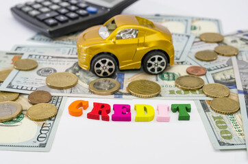 toy car, money and the word "credit" from letters. , car loan / investment concept.
