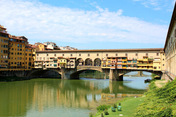 Fototapeta na wymiar Ponte Vecchio, an ancient bridge across Arno river, in city Florence, Italy in a beautiful summer day.