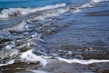 sea waves with foam in sunny weather