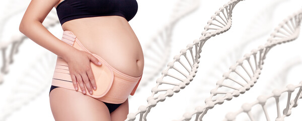 Pregnant woman in beige bandage for pregnancy among DNA stems.
