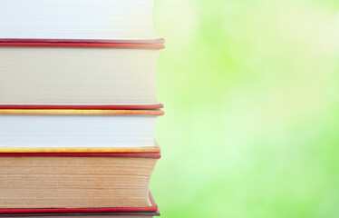 stack of books on the nature blurred background