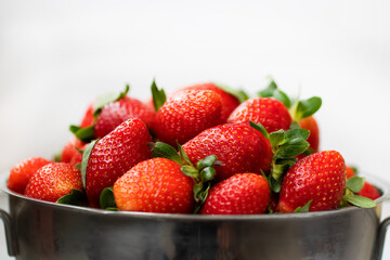 Organic strawberry in metal bowl. Close-up.