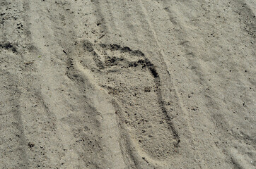 Fototapeta na wymiar human footprint in hot beach sand