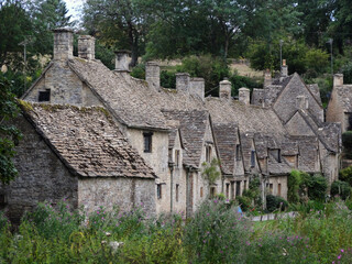 Fototapeta na wymiar Stone cottages in Bibury town, Cotswolds, England, UK