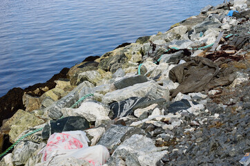 garbage on rocky sea shore