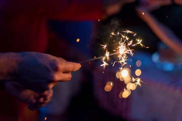 Lighting sparklers in the backyard at a family celebration