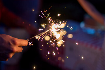 Lighting sparklers in the backyard on a summer evening - 360024046