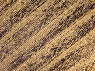 abstract texture of harvested field with brown diagonal stripes for design and background