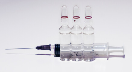 Medical ampoules with syringe on the white background