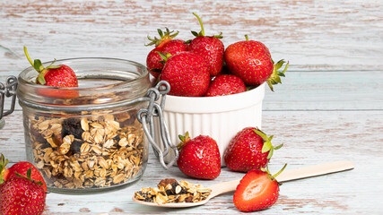  granola with fresh strawberry on white wooden table for healthy breakfast with copy space