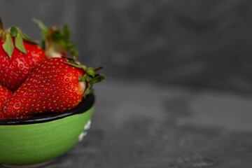 Ripe red strawberries. Bowl filled with juicy fresh ripe red strawberries. strawberries on a grey...