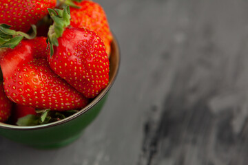 Ripe red strawberries. Bowl filled with juicy fresh ripe red strawberries. strawberries on a grey concrete table. Fresh strawberries photo. Сoncept healthy food