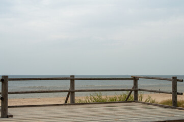 Naklejka na ściany i meble wooden viewpoint deck against a quiet calm sea landscape