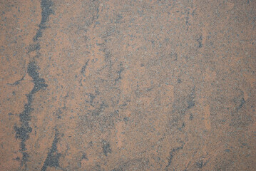 The texture of the stone wall, smooth brown stone texture with gray and black spots. Pattern for designers.
