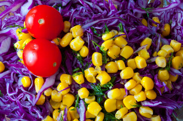 Corn and red cabbage salad with tomatoes.