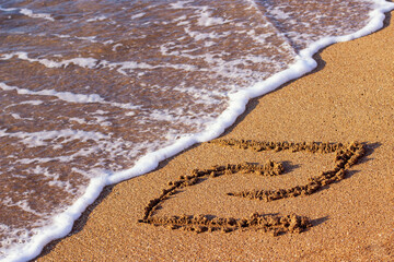 Fototapeta na wymiar Israeli shekel symbol in the sand near the sea