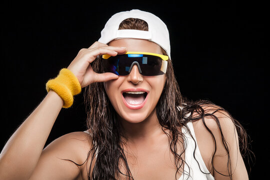 Sporty young woman with modern sunglasses, wet hair and cap. Active and healthy lifestyle concept
