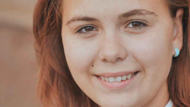 Portrait of a 16 year old red-haired smiling girl.