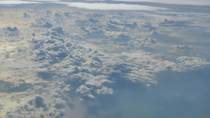 Clouds and part of the wing of the aircraft window.