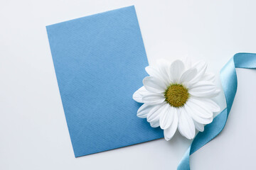 card for invitation or congratulation with flowers. blue card with white flower