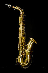 a complete view of a gold saxophone with mechanisms and buttons, an elegant and complex but beautiful wind instrument
