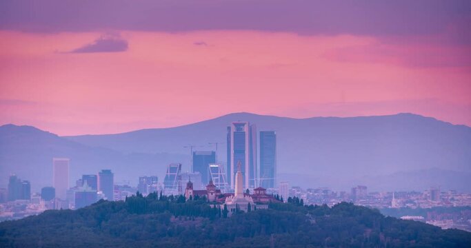Time lapse of Madrid skyline from the distance during sunset. Day to night Madrid and mountains in the background