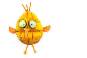 Food art creative concepts. Funny bird made of fruits and vegetables, such as orange, mango and carrots isolated on a white background